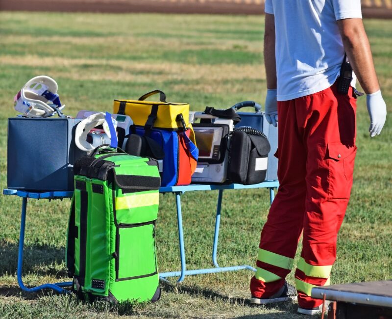 Event medical equipment staged at the side of a sports field